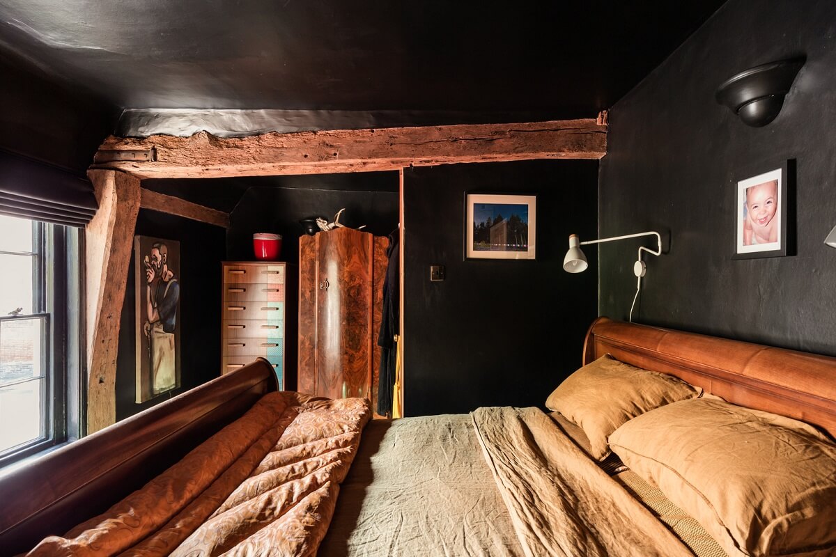 all black bathroom exposed wooden beams