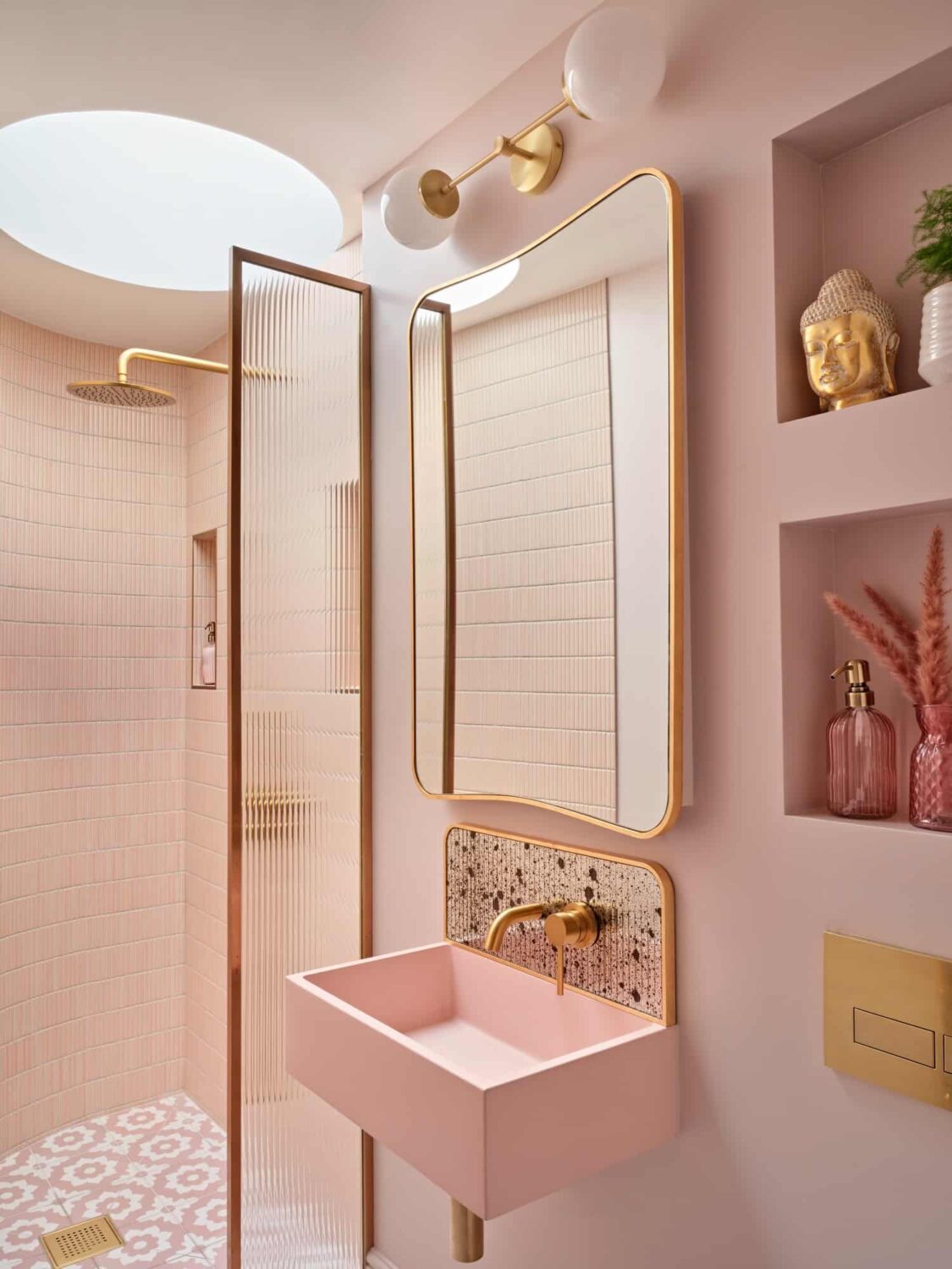 all pink bathroom with walk in shower pink sink and storage niches