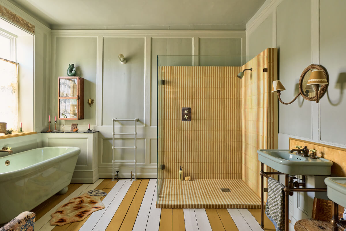 bathroom large shower freestanding bath painted wooden floorboards