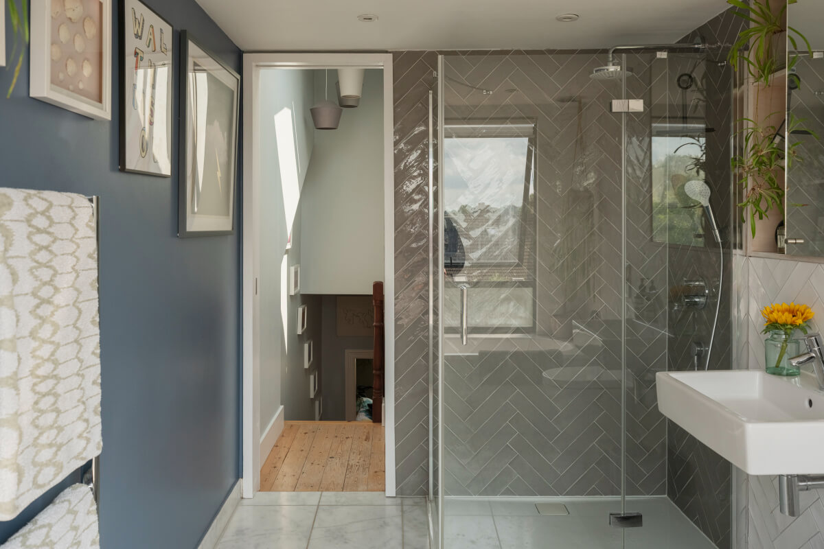 bathroom walk-in shower gray herringbone tiles