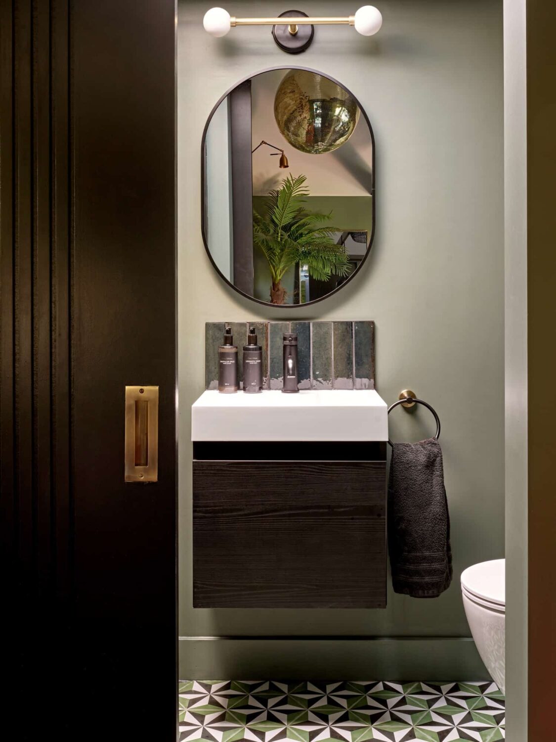 bathroom with sliding door and geometric floor tiles