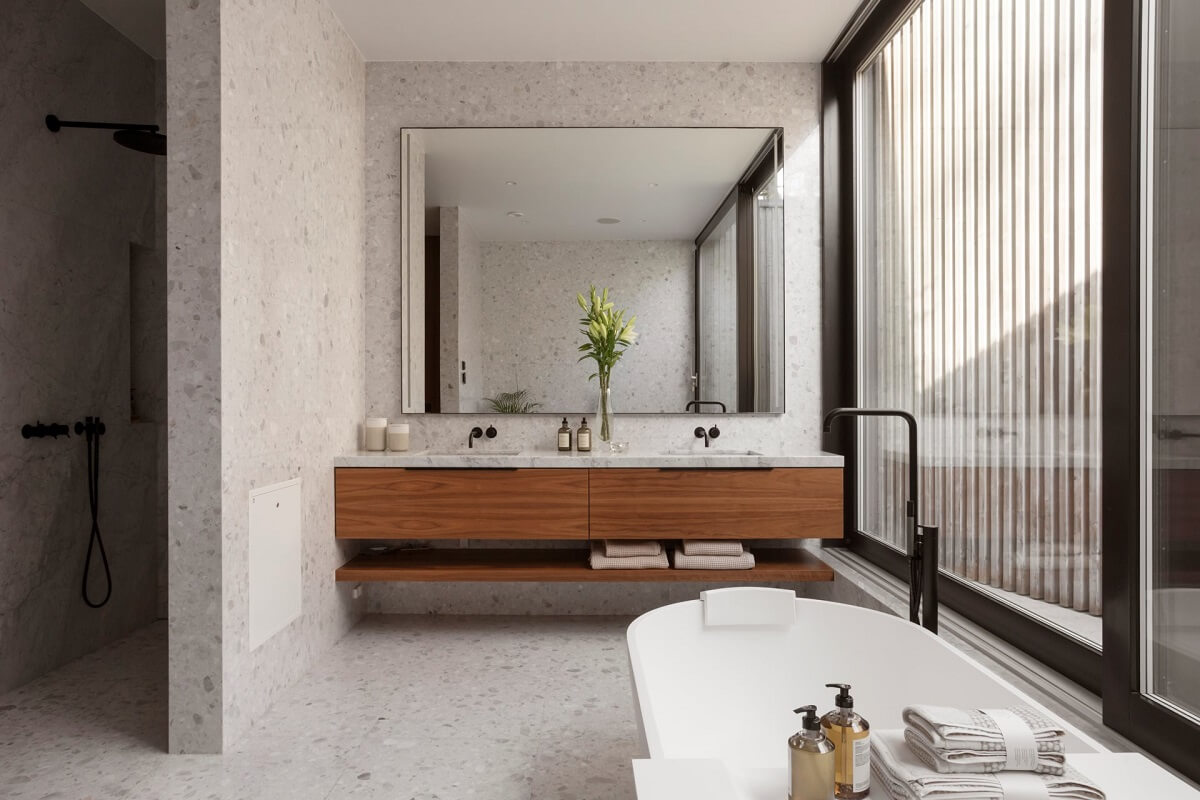 bathroom with walk in shower and wooden accents