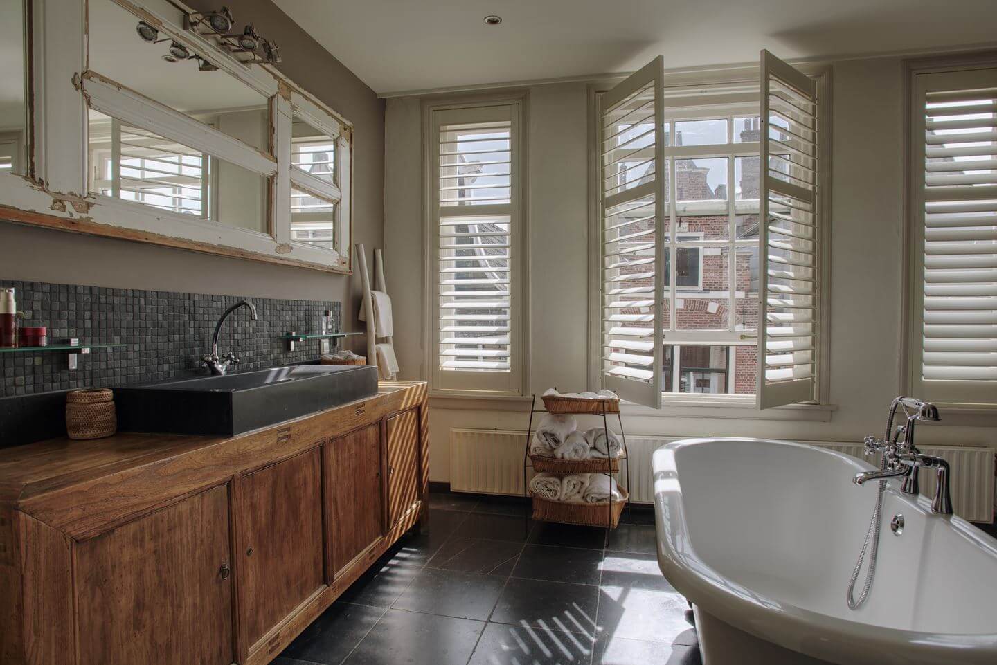 bathroom with wooden vanity and bath