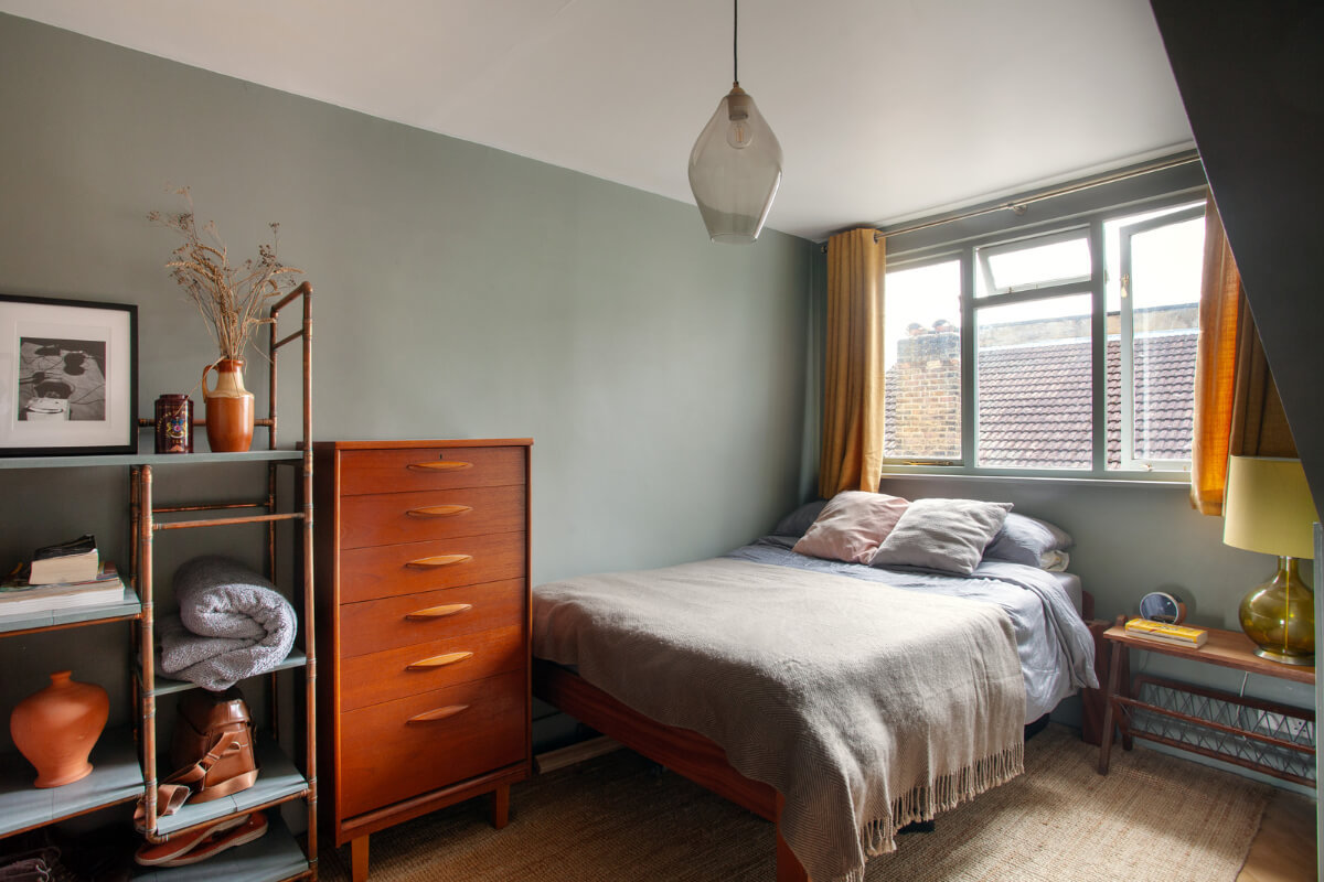 bedroom blue-green walls midcentury cabinet