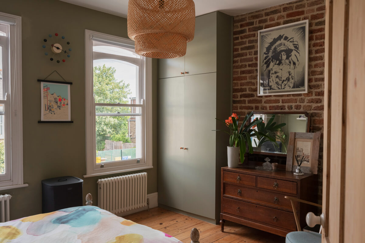 bedroom exposed brick wall built-in gray wardrobes