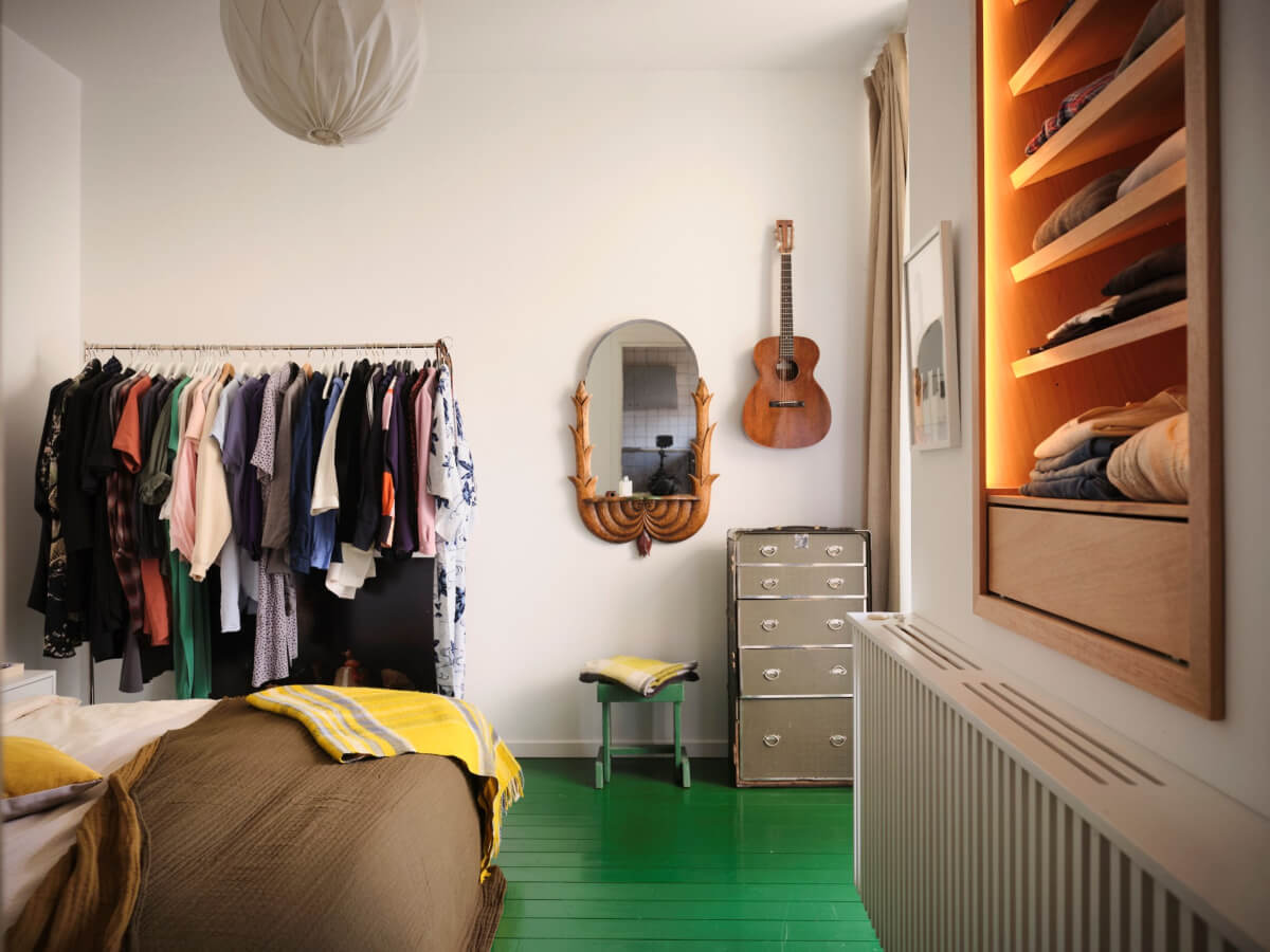 bedroom green painted wooden floorboards clothing rack