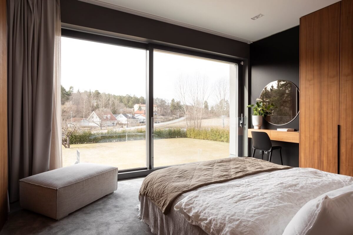 bedroom with black walls and wooden wardrobes