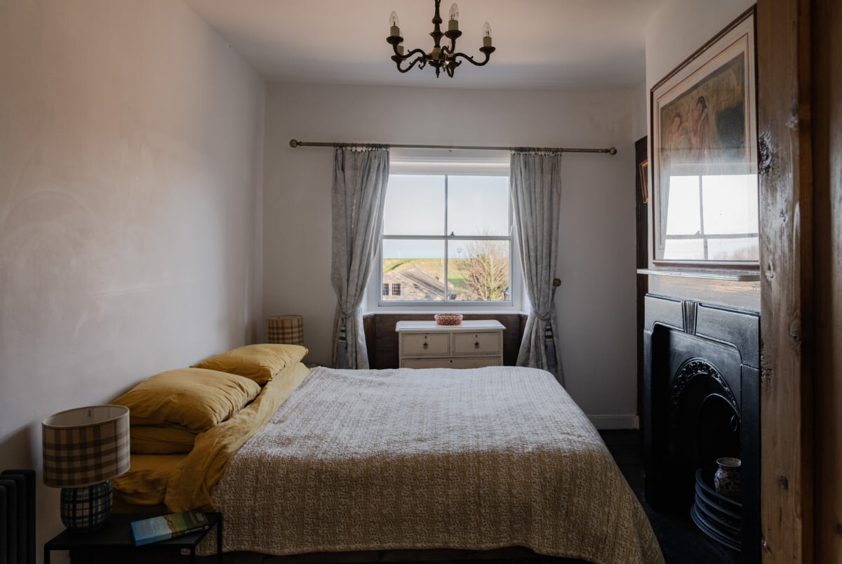 bedroom with fireplace and light gray walls