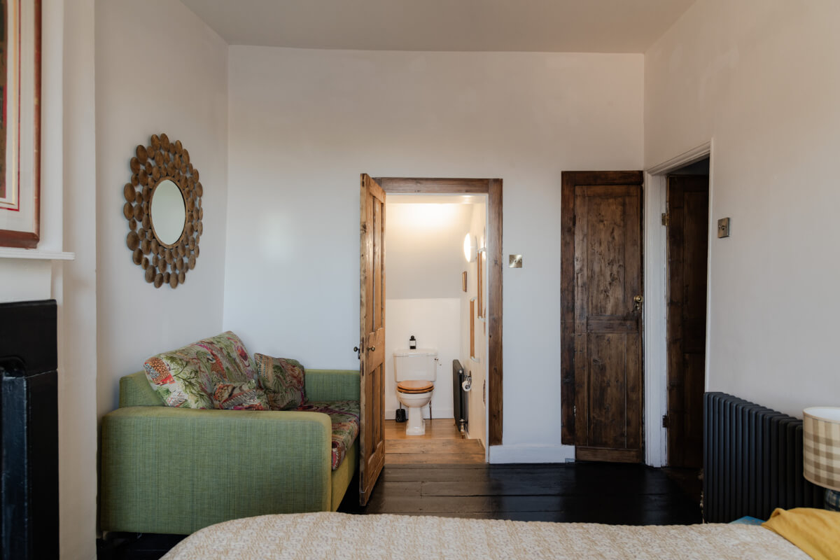 bedroom with green couch