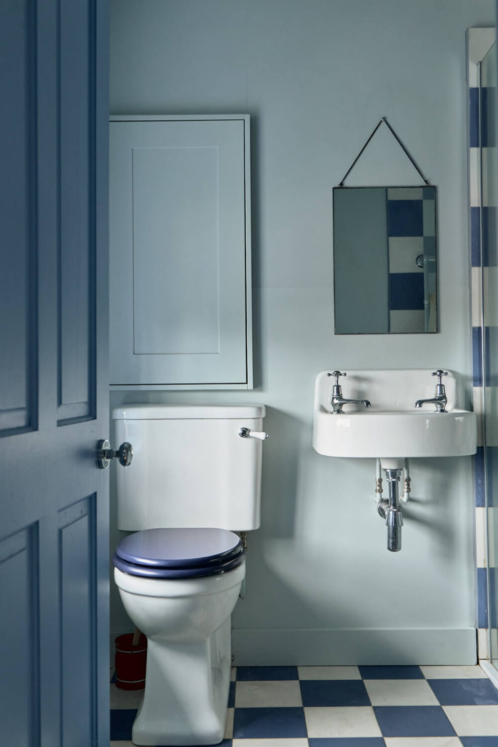 blue bathroom with checkerboard tiles
