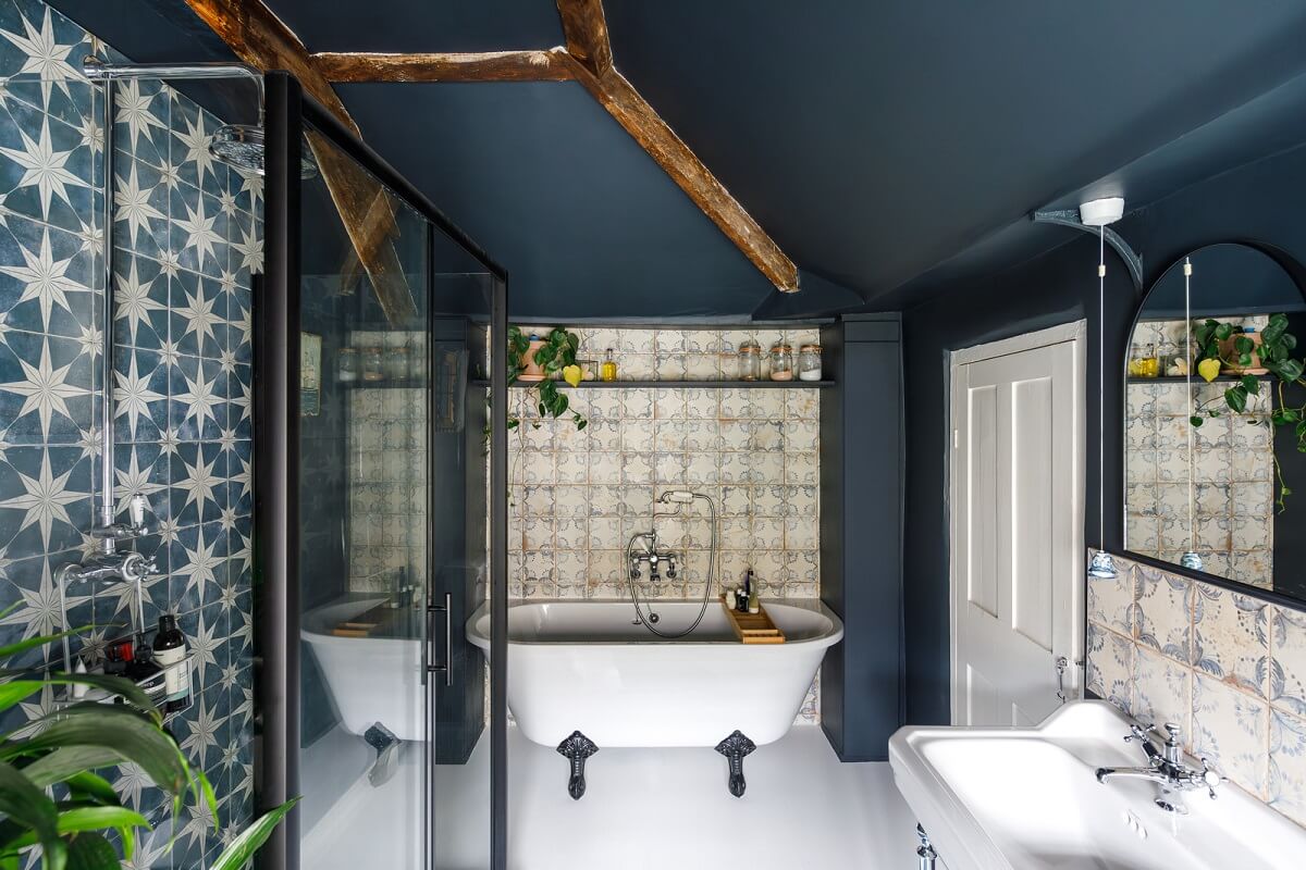 blue bathroom with clawfoot bath and ceiling beams