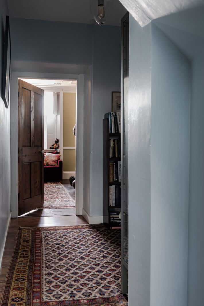 blue hall with large vintage rug