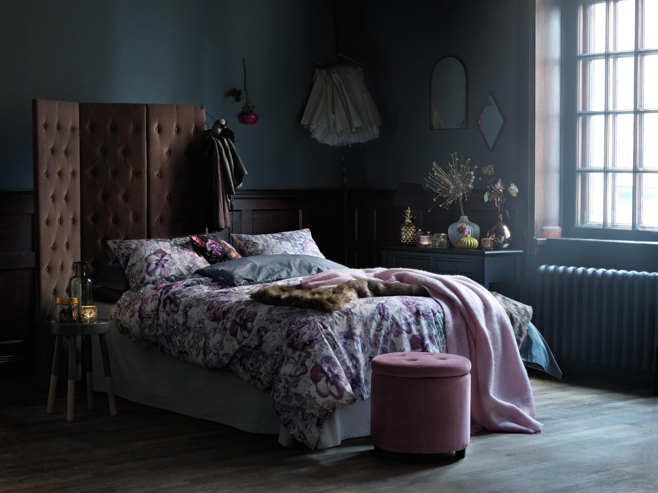 dark bedroom with velvet pink screen used as headboard nordroom