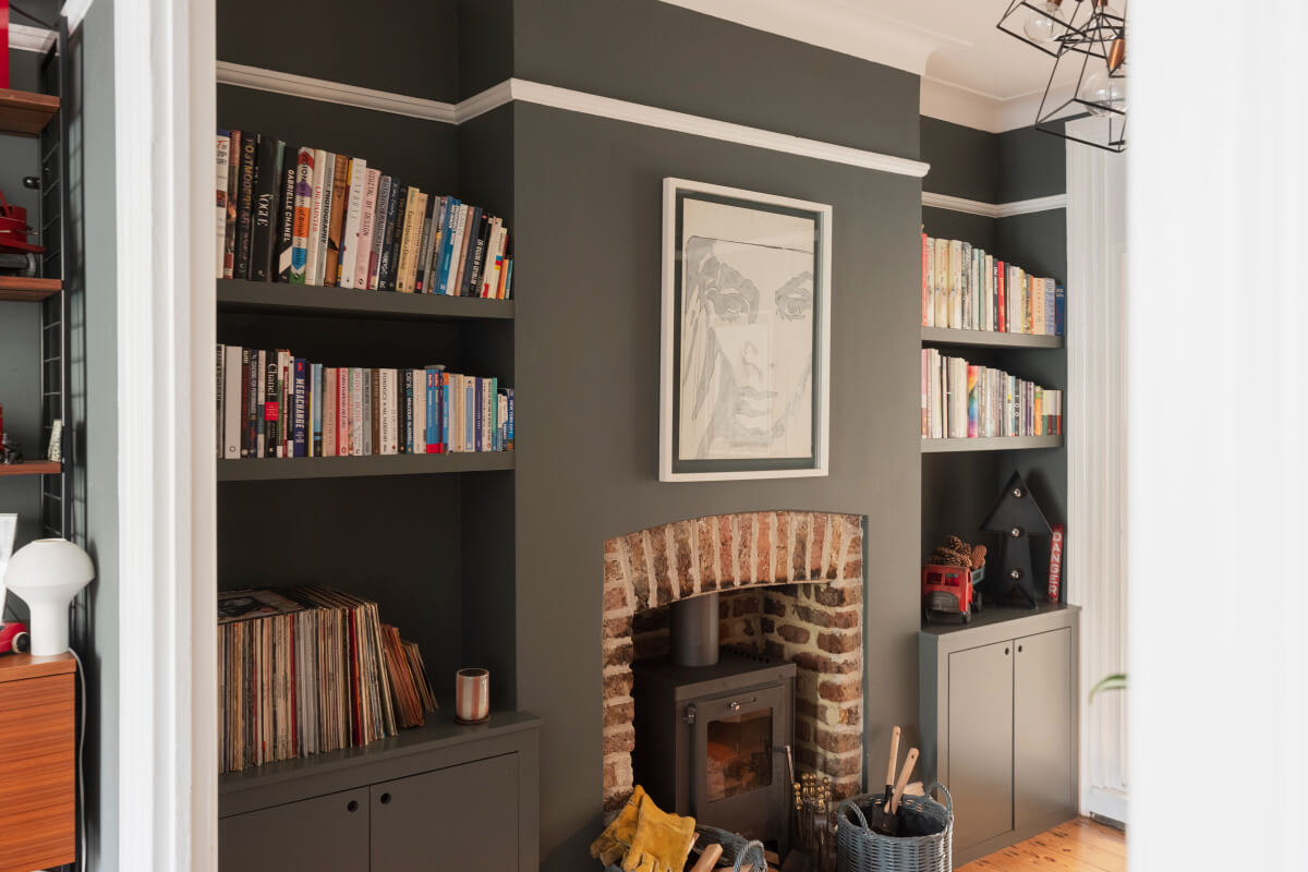 dark gray living room brick fireplace built-in bookshelves