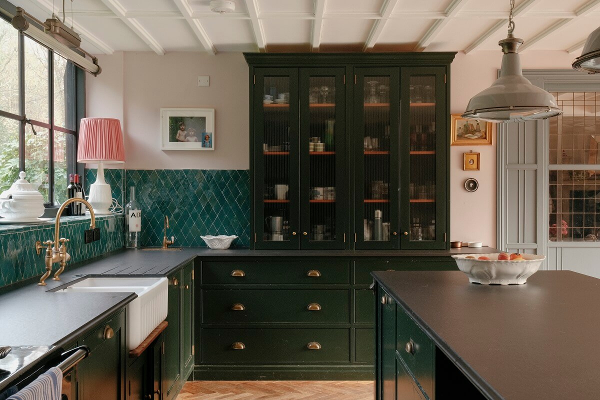 dark green devol kitchen with glass cabinets and glossy green backsplash tiles