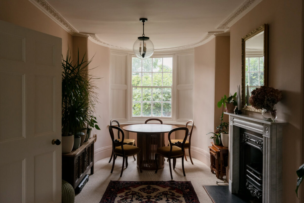 dining room pink walls bay window