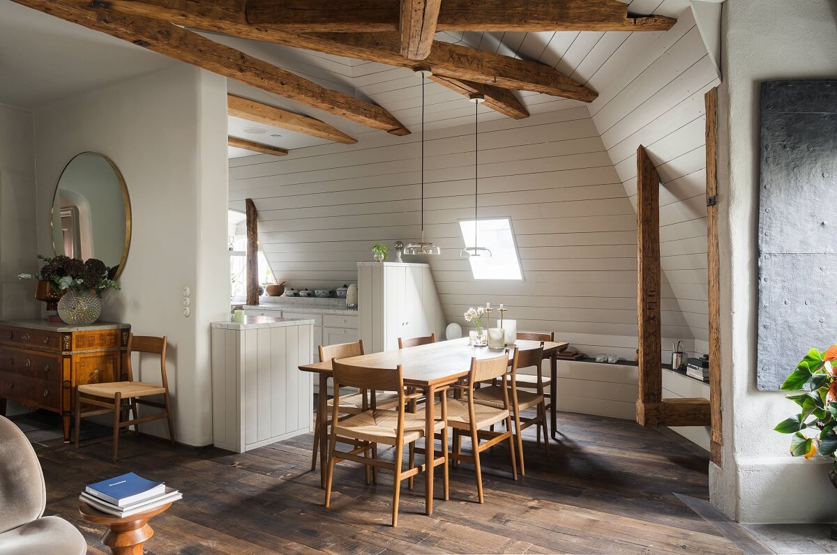 dining space slanted ceiling exposed wooden beams