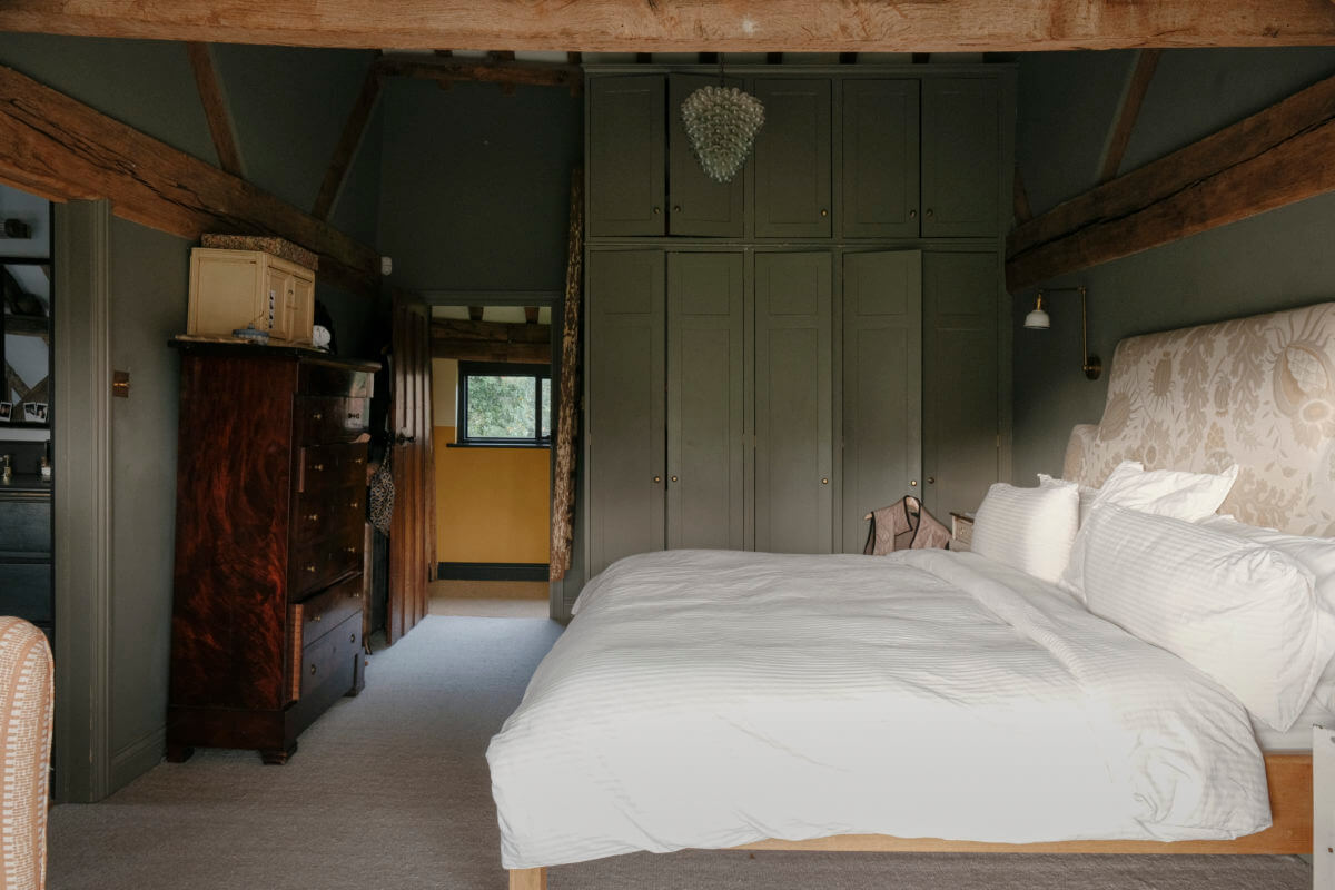 exposed beams in green bedroom
