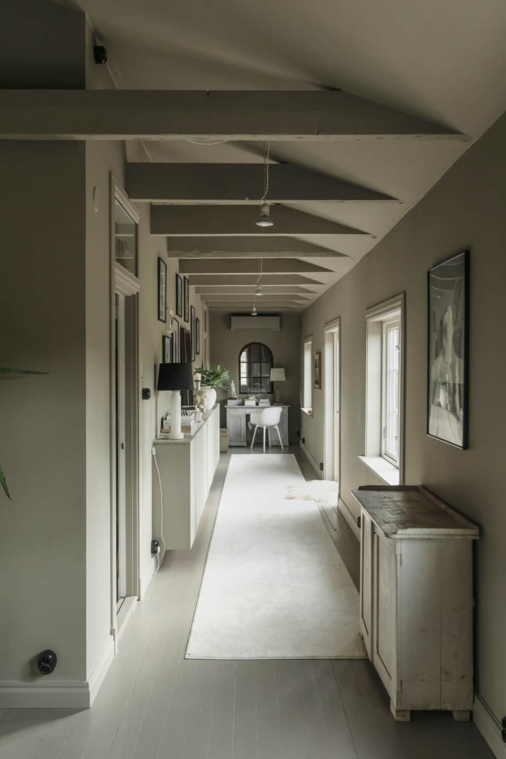 gray hall with cabinets and desk