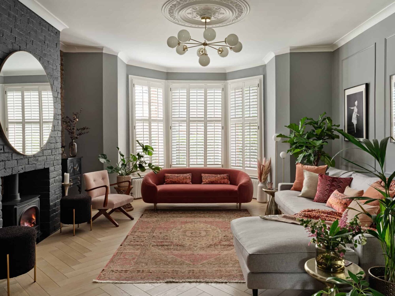gray living room with bay window and painted brick fireplace nordroom