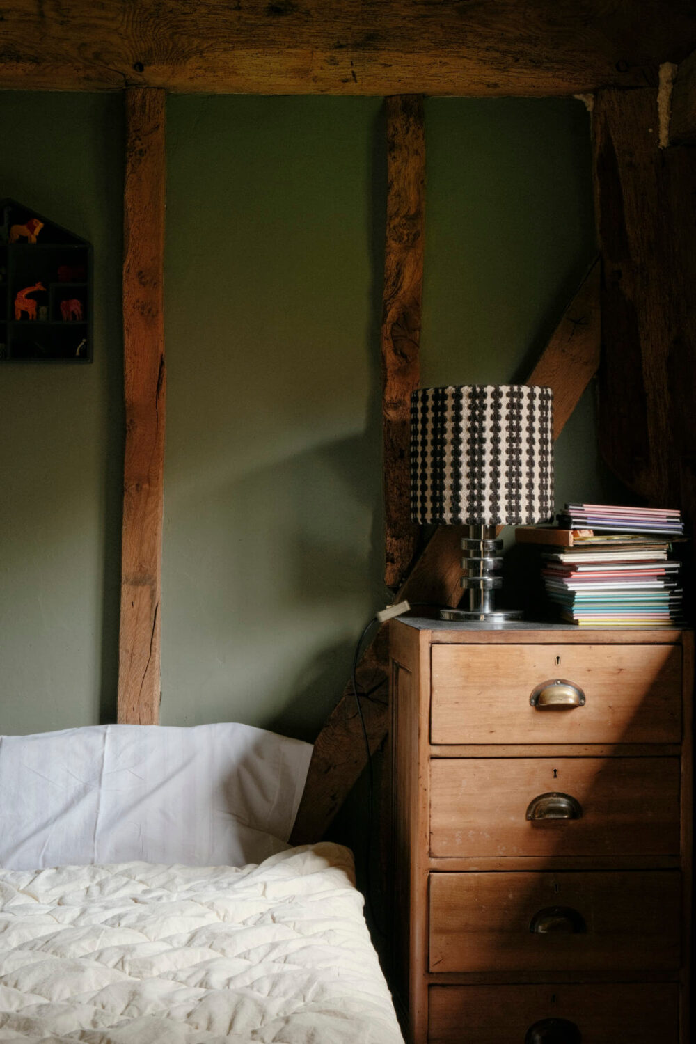 green bedroom with exposed beams