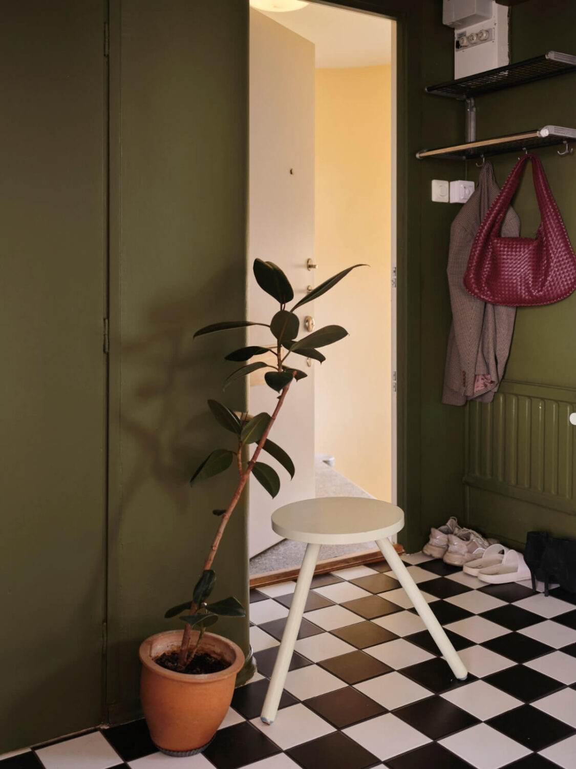 green hall black and white checkerboard floor A 1940s Swedish Apartment with a Soft Yellow Kitchen