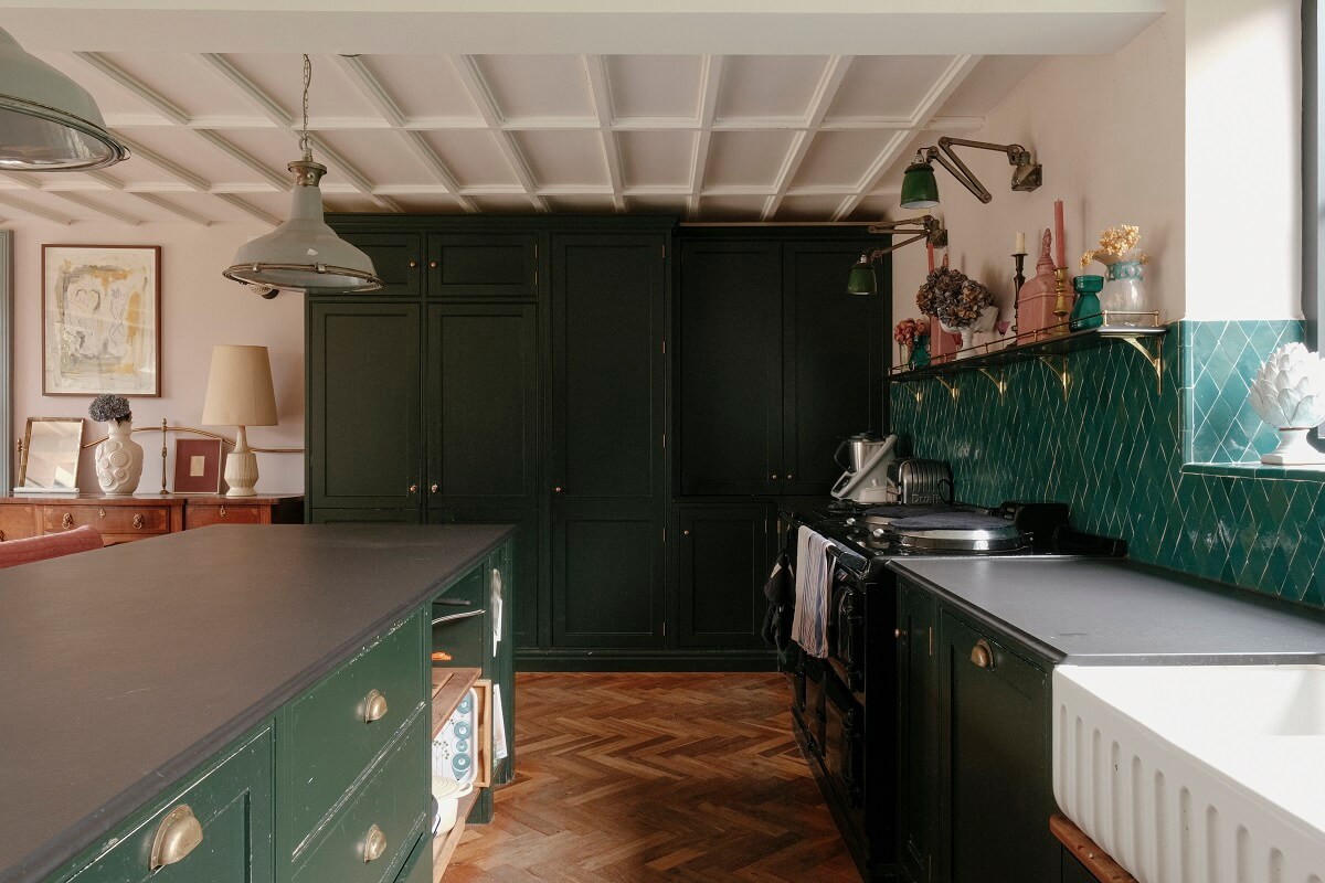 green kitchen with island and floor to ceiling cabinets