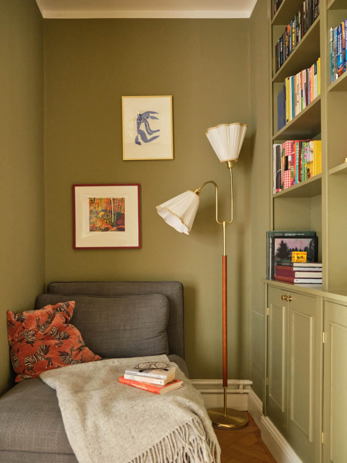 green reading nook with built-in bookshelves