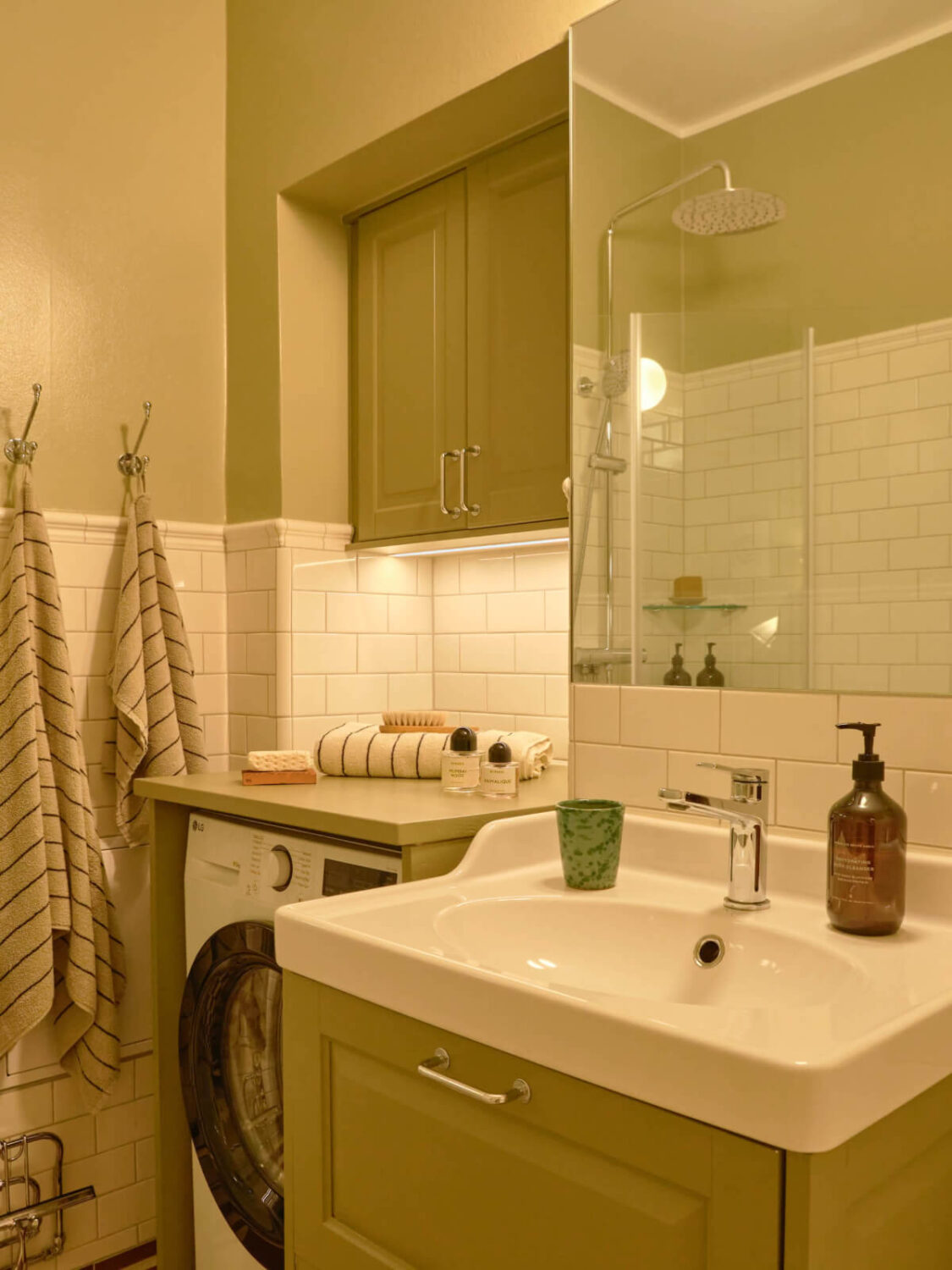 green walls and cabinets bathroom