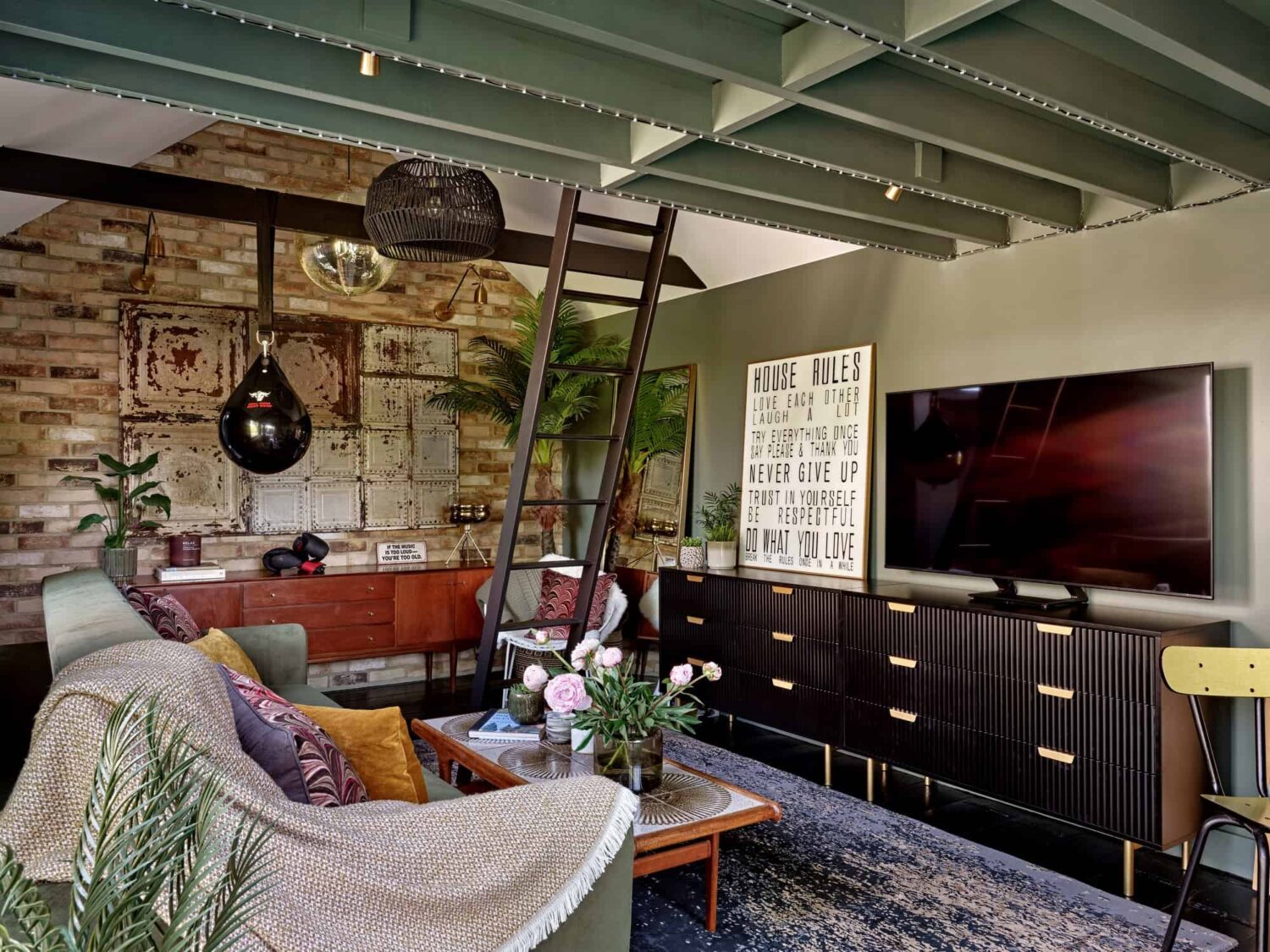 guest house living room with painted wooden ceiling and exposed brick wall