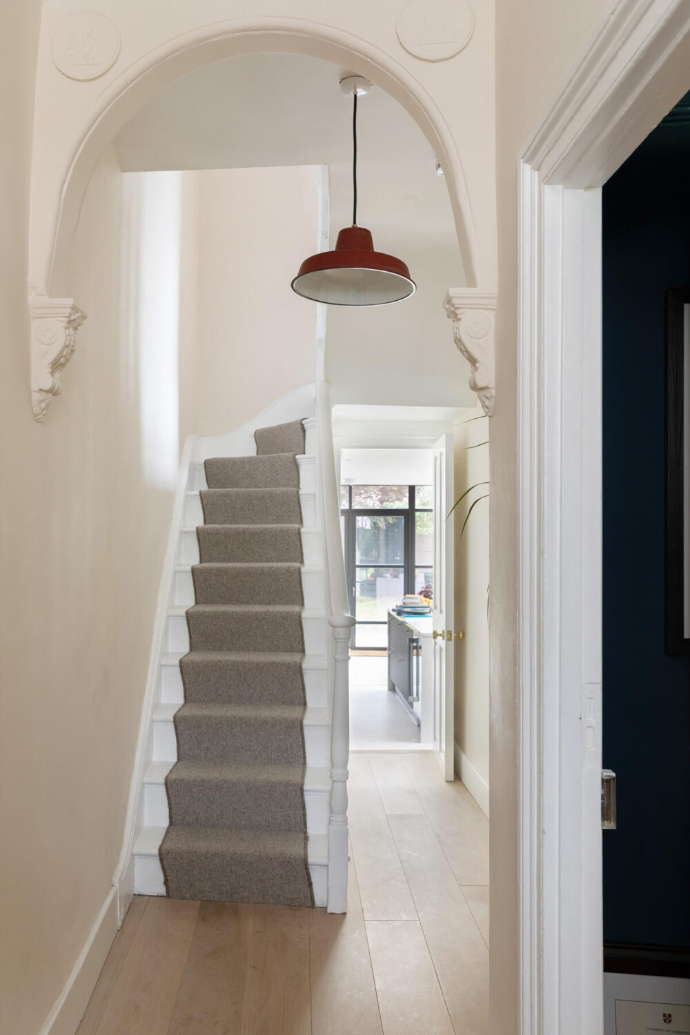 hallway with arch staircase
