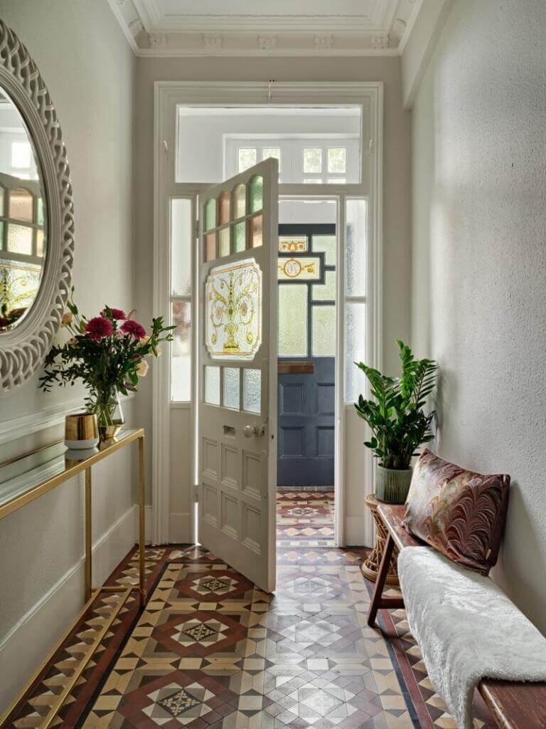 hallway with victorian floor tiles and bench
