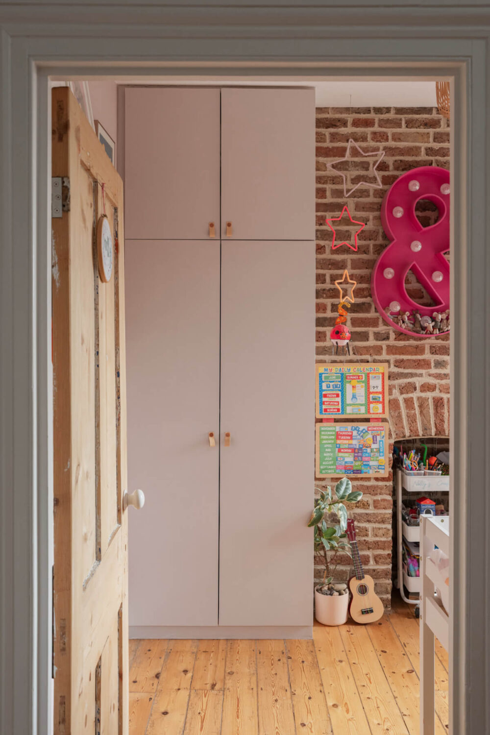kids bedroom exposed brick pink wardrobe
