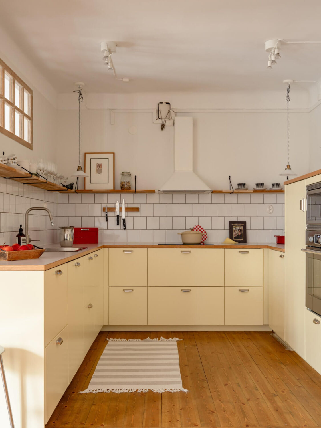 kitchen pale yellow cabinets wooden countertop