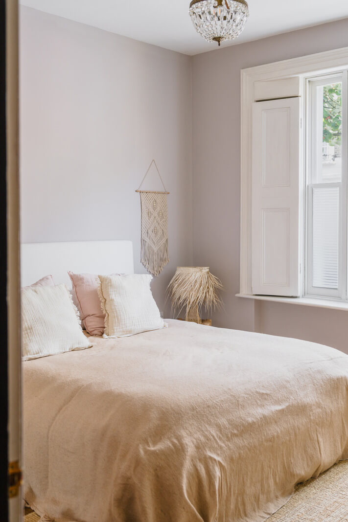 light bedroom with gray walls and white shutters