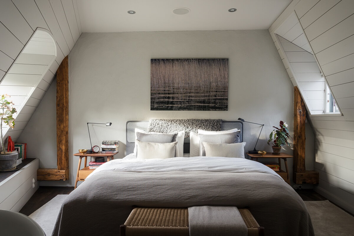 light gray bedroom slanted ceilings wooden beams