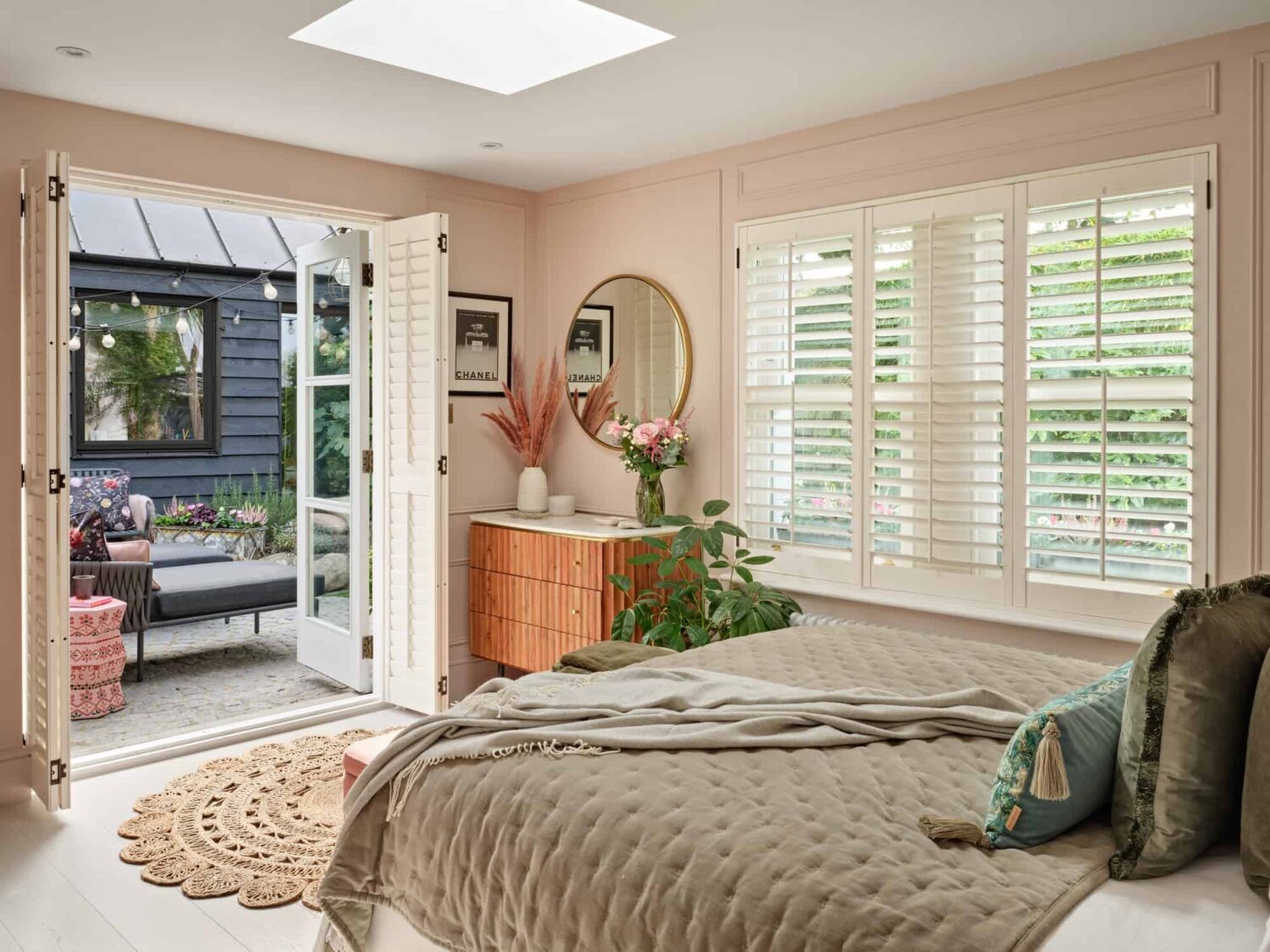 light pink cottage style bedroom with skylight