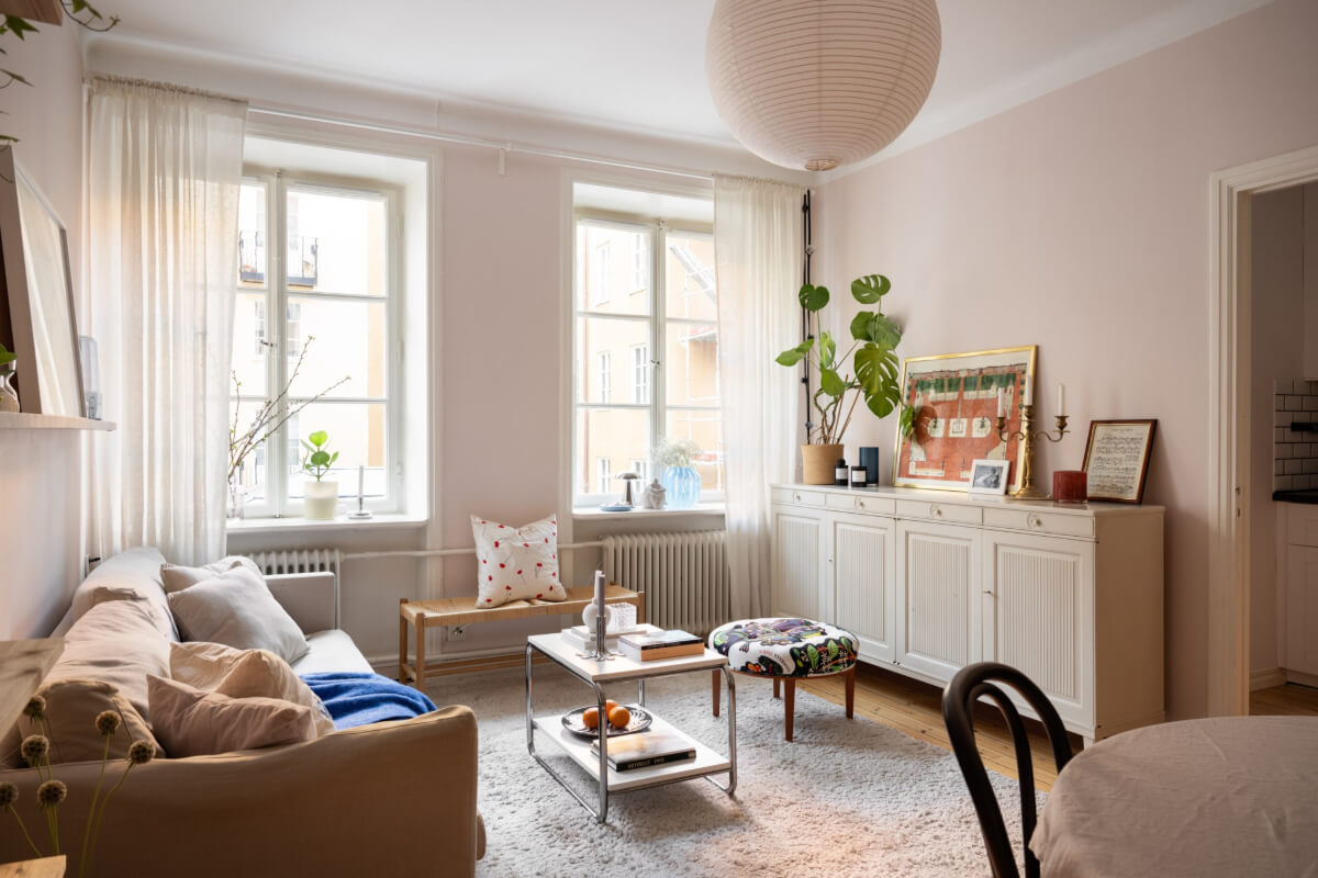 living room light pink walls wooden floor