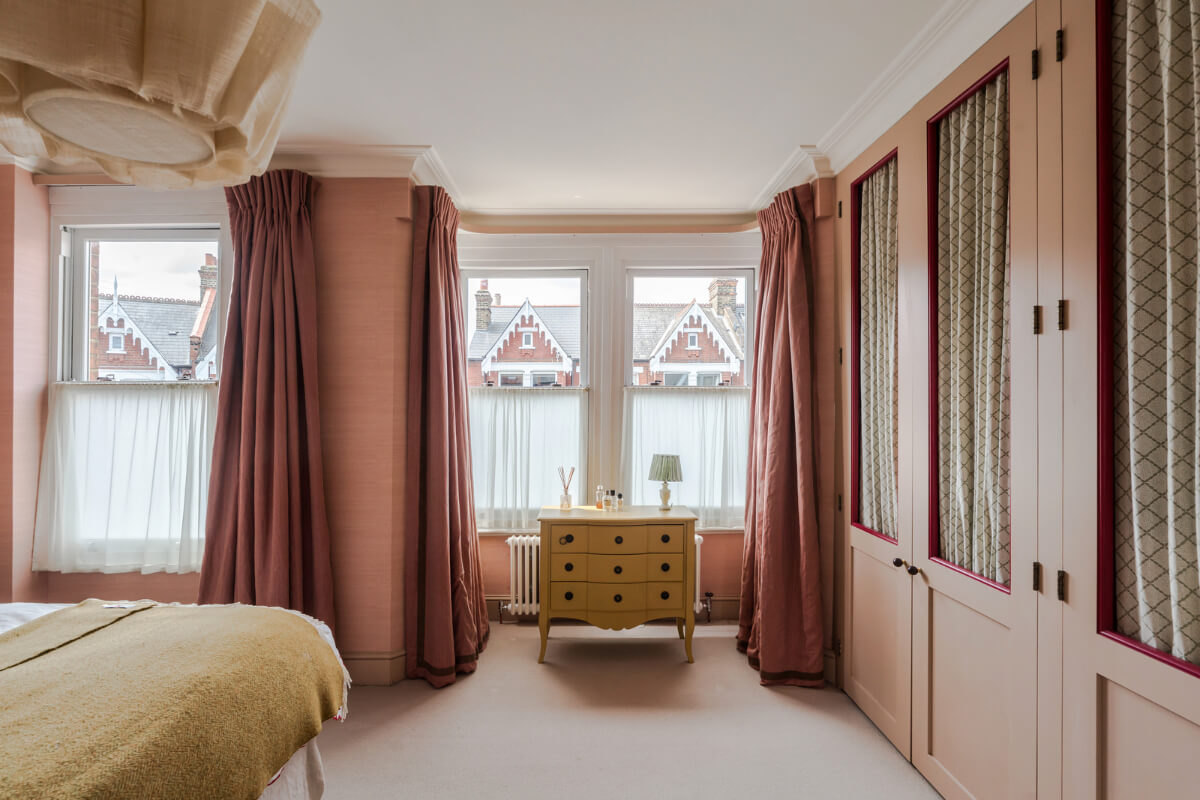 master bedroom pink wallpaper built-in wardrobes with curtains