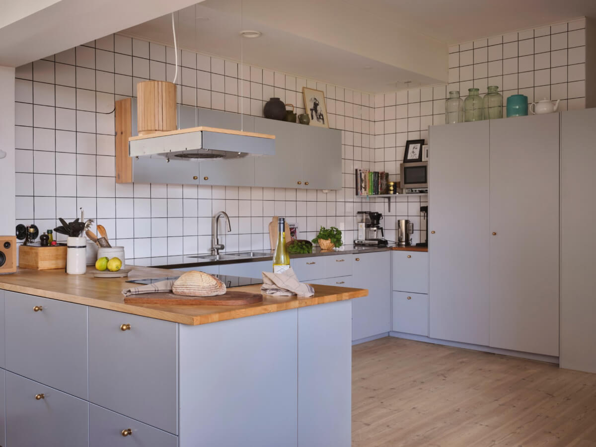 modern light gray kitchen brass knobs white tiles