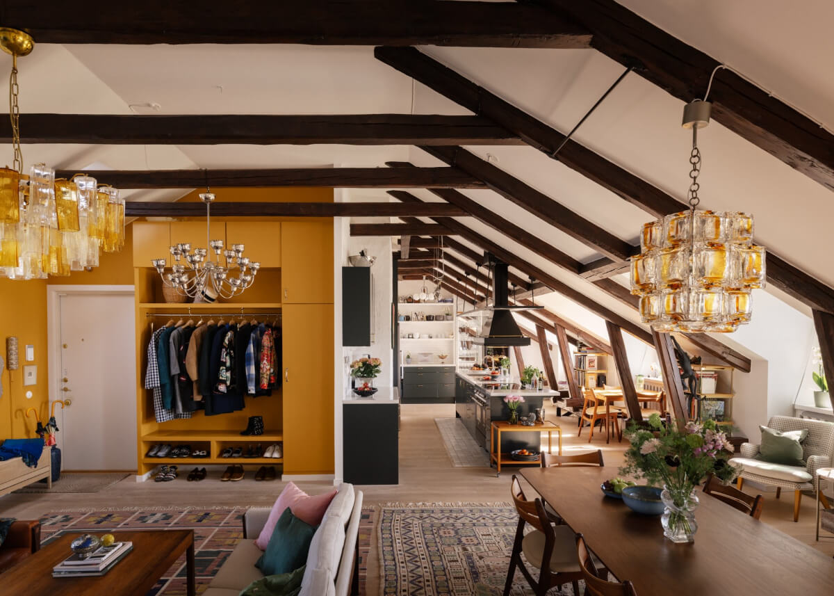 open-plan penthouse apartment wooden beams yellow built-in storage