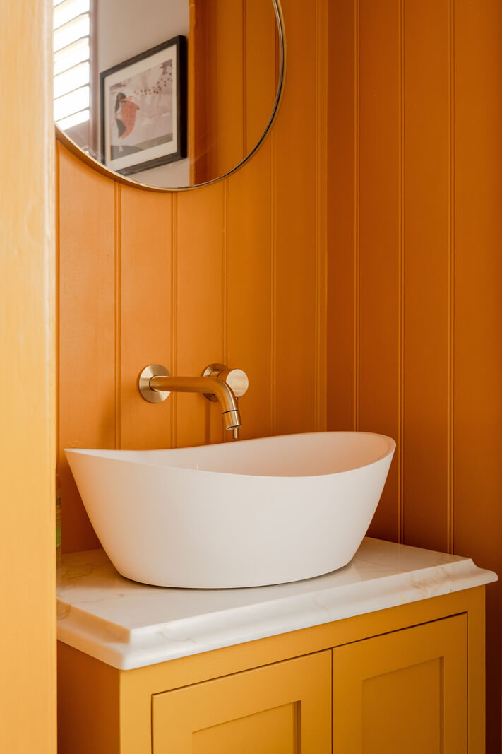 orange bathroom sink cabinet paneled walls