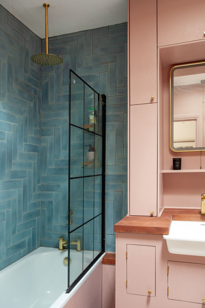pink cabinets and blue tiles small bathroom