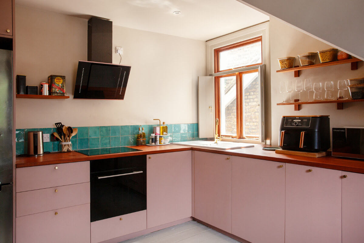 pink kitchen with turquoise tiles
