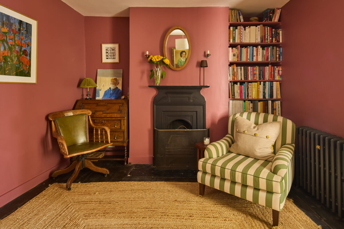 pink sitting room striped chair built-in shelves fireplace