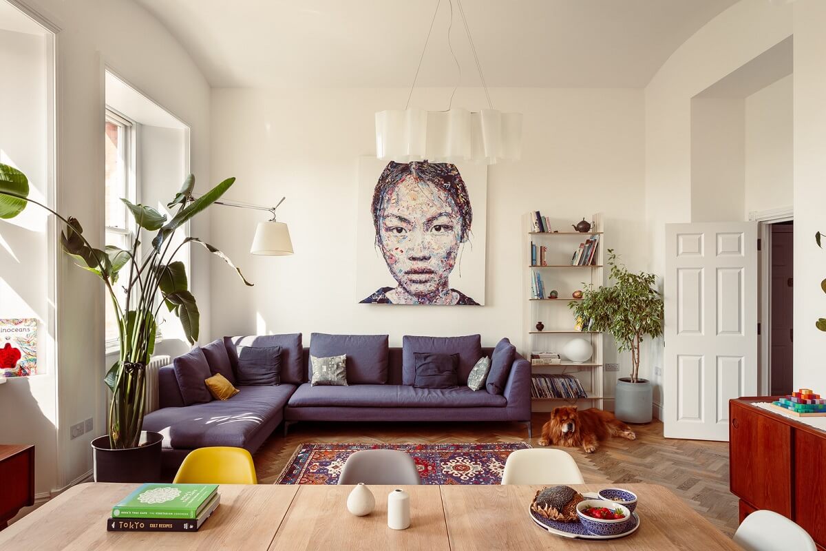 purple sofa in light living space with wooden floor