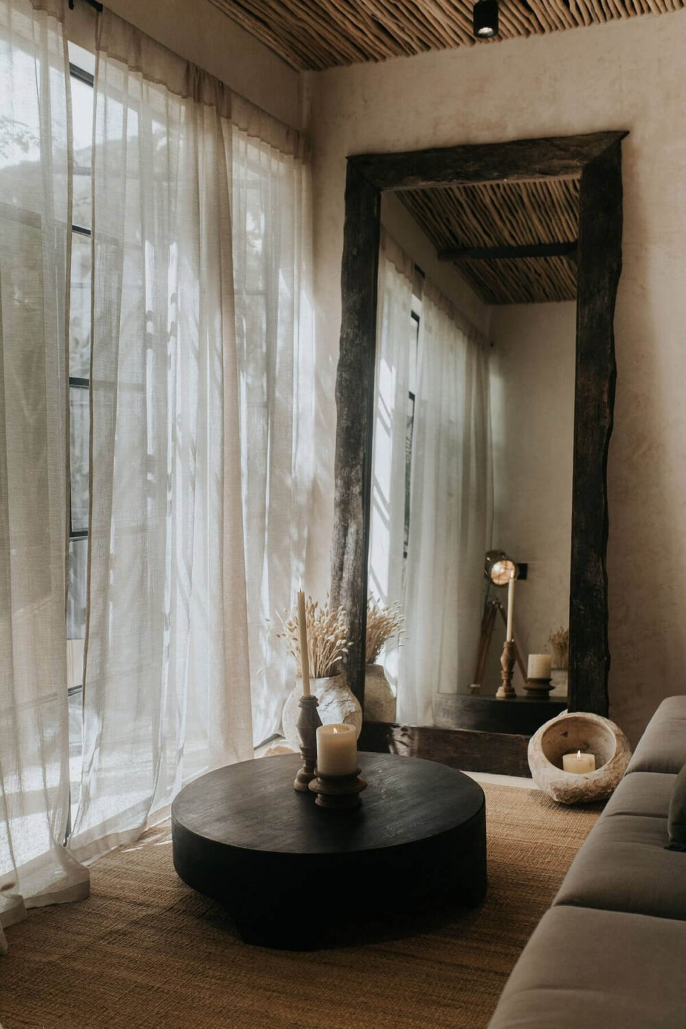 round-coffee-table-jute-rug-large-rustic-wooden-mirror-living-room-nordroom