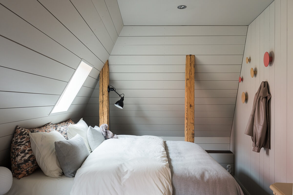 scandi bedroom slanted ceiling wooden beams