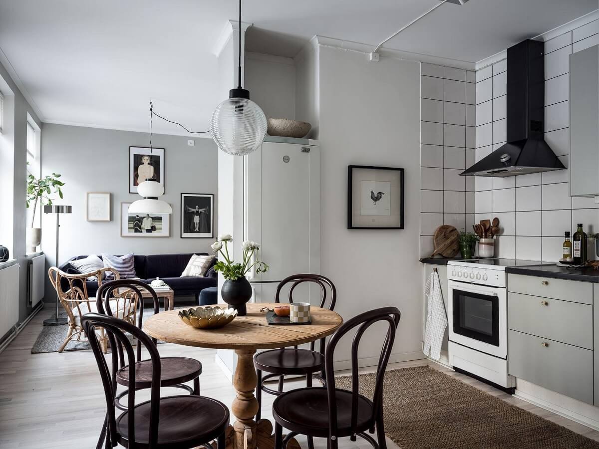 scandi studio apartment light gray kitchen round wooden table nordroom