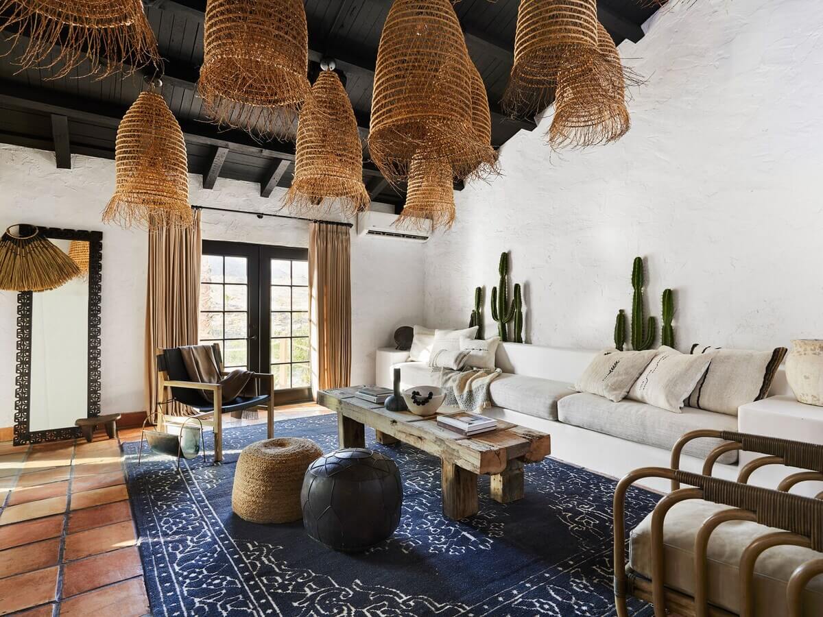 sitting-room-stone-floor-blue-rug-black-painted-wooden-ceiling-nordroom